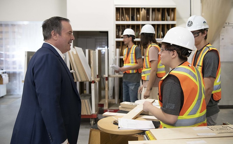 Premier Jason Kenney visits a millwork facility in Calgary.